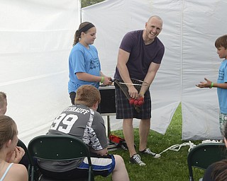 Katie Rickman | The Vindicator.Jennifer Phillis 11 of Beloit on left and Matthew Baird 9 of Salem on right assist magician Jason Alan during a magic show at the 5th annual Carnival  at Damascus Elementary School on May 9, 2015.