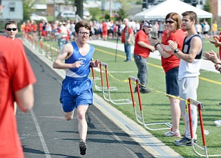 Jeff Lange | The Vindicator  MAY 9, 2015 - Stark Public Special Olympics' Cameron Broom is applauded by volunteers as he nears the finish line of the 1,500 meters run during Saturday's Special Olympics at Arrowhead Stadium in Girard.
