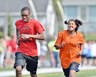 Jeff Lange | The Vindicator  MAY 9, 2015 - Columbiana County's Adina Maxwell (right) sprints down the track in the 100 meter dash with volunteer Collin Harden of Girard High School, Saturday during the Special Olympics in Girard.