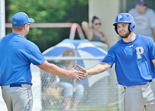 Jeff Lange | The Vindicator  MAY 9, 2015 - Poland's Anthony Calcagni (right) is greeted by third base coach Christ Martin after advancing to third in the bottom of the fourth inning of Saturday's game against Springfield.