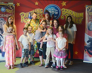 Katie Rickman | The Vindicator.Members of the Warren Family Mission were hosted at the opening night of the Ringling Bros and Barnum & Bailey circus at the Covelli Centre on May 7, 2015.  From l-r.Desiree Estep hugs Alexis Hoysack 10, James Hoysack 7, Johnathan Hoysack 8,  Destinini Seastrand (holding, middle) Aubrey Wojsiak 2, Samantha Wood 7, Jessie Wood (Director of the mission, wearing red shirt), Cassie Boyer 7 (wearing pink), Megan 6 (was not able to give last name), and Charlotte Lightner 11. They pose with the clowns Sandor (on left) and Andrew.
