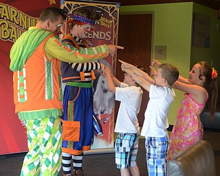 Katie Rickman | The Vindicator.Alexis Hoysack 10, on far right, point with her brothers James 7, and Johnathan 8 (middle) at two of the circus clowns (Sandor on left and Andrew) at a meet and greet session prior to the circus on May 7, 2015.