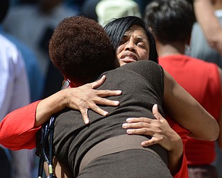 Katie Rickman | The Vindicator.Vita Morgan, an Evangelist of Youngstown prays for LaTheressa Morgan of Warren during the National Day of Prayer ceremony downtown Youngstown on May 7, 2015.