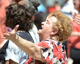Katie Rickman | The Vindicator.Joyce Morucci raises her hands as she worships to the song “Break Every Chain” during the National Day of Prayer ceremony downtown Youngstown on May 7, 2015.