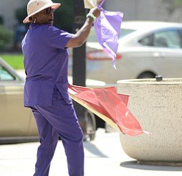 Katie Rickman | The Vindicator.Lola Slaughter of Youngstown waves flags as she dances  during the National Day of Prayer ceremony downtown Youngstown on May 7, 2015.