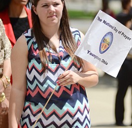 Katie Rickman | The Vindicator.Alisha Hetherington of Warren holds a “National Day of Prayer” poster during the National Day of Prayer ceremony downtown Youngstown on May 7, 2015.
