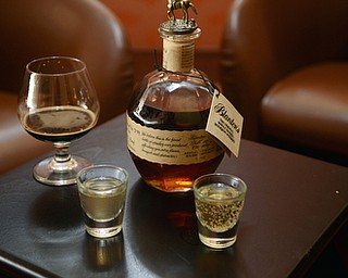 Katie Rickman | The Vindicator.Ryes Craft Beer & Whiskey is one of the newer bars Youngstown, the business is celebrating its first full year May 7, 2015.  Whiskey and a craft beer sit on table near smaller couch like chairs in front of the fireplace.