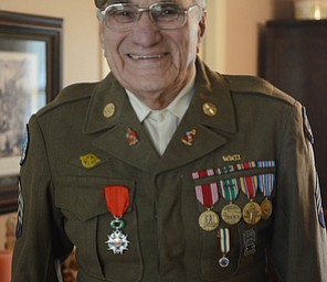 Katie Rickman | The Vindicator.Vince Bellanca of Youngstown was in the 44th Infantry Division in WW2, in this photo he wears his jacket from his uniform (He still fits in it!). Bellanca discusses his reaction on VE Day.