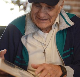 Katie Rickman | The Vindicator.Vince Bellanca of Youngstown was in the 44th Infantry Division in WW2, he looks through a photograph album from his years in service.  Bellanca discusses his reaction on VE Day.
