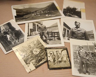 Katie Rickman | The Vindicator.Photographys spread out over a portion of the dining room table at the home ofVince Bellanca of Youngstown who was in the 44th Infantry Division in WW2. The photographs are of Bellanca and comrads and also of a family he met while abroad.  Bellanca discusses his reaction on VE Day.