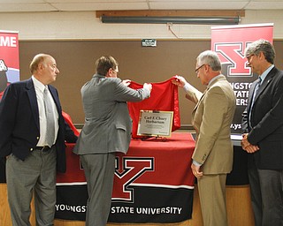        ROBERT K. YOSAY  | THE VINDICATOR..The herbarium at Youngstown State University, featuring a collection of more than 100,000 plant specimens, WAS dedicated in memory of the late Carl F. Chuey, professor of Biology..President James P Tressel  unveils the plaque in Dr Chueys honor with the help of Matthew( son as his brother james (left )and Dr Greg Sturrus interrum dean  look on