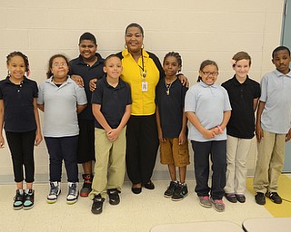 Katie Rickman | The Vindicator.Angela McCoy, center, poses with a few of the children in her gospel choir at Williamson Elementary on April 8, 2015. L-R.Shania Eiland 10, Kathryn Carter 10, Joshua Fitzgerald, 11, Xavier Cuevas 11, Angela McCoy, Joshua Rheins 10, Teriana Laster 9, Isabel Hyson 10, Deric Hunter 10.