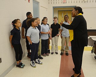 Katie Rickman | The Vindicator.Angela McCoy who is a Parent Advocate at Williamson Elementary started off as a volunteer at the school 9 years ago.  She smiles as she directs a small group of the children’s choir at Williamson Elementary on April 8, 2015.