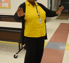 Katie Rickman | The Vindicator.Angela McCoy who is a Parent Advocate at Williamson Elementary started off as a volunteer at the school 9 years ago.  She smiles as she directs a small group of the children’s choir at Williamson Elementary on April 8, 2015.