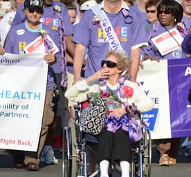 Katie Rickman | The Vindicator.Honorary Queen Rosemary Blicher 92  blows a kiss during the start of the Survivor walk as she is wheeled by honorary King Gary Mower 57 on Friday May 8, 2015.