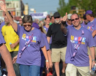 Katie Rickman | The Vindicator.Nick Macrinos of Warren gives the thumbs up as Charlotte Adams of Howland waves during the survivor walk at Warren Relay For Life on Friday May 8, 2015.