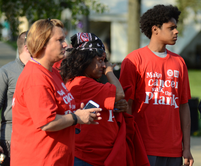 Katie Rickman | The Vindicator.L-R Tammy Daggy of Salem, Marisol Gonzalez of Liberty, and William Bowers 17 of Liberty react as cancer survivors take the first lap at Warren Relay For Life on Friday May 8, 2015. They were attending the event in honor of Bill Bowers, father of William, who is currently fighting cancer.