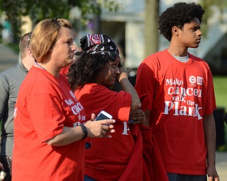 Katie Rickman | The Vindicator.L-R Tammy Daggy of Salem, Marisol Gonzalez of Liberty, and William Bowers 17 of Liberty react as cancer survivors take the first lap at Warren Relay For Life on Friday May 8, 2015. They were attending the event in honor of Bill Bowers, father of William, who is currently fighting cancer.