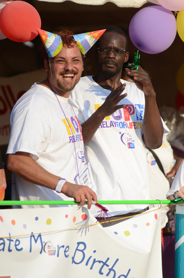 Katie Rickman | The Vindicator.Eric Cassidy of Warren smiles as teams take a lap around the square, his friend Richard Turner also of Warren is next to him at Warren Relay For Life on Friday May 8, 2015.