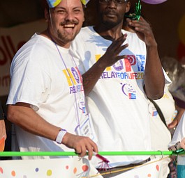Katie Rickman | The Vindicator.Eric Cassidy of Warren smiles as teams take a lap around the square, his friend Richard Turner also of Warren is next to him at Warren Relay For Life on Friday May 8, 2015.