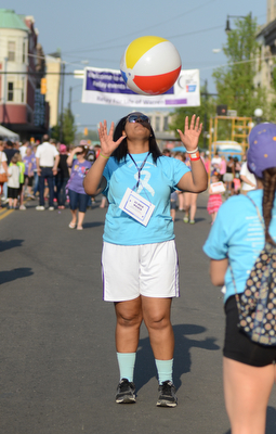 Katie Rickman | The Vindicator.Kyra Lower 17 of Warren tosses a beach ball in the air while dancing in the street at Warren Relay For Life on Friday May 8, 2015.