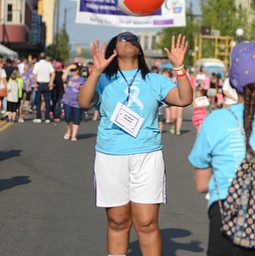Katie Rickman | The Vindicator.Kyra Lower 17 of Warren tosses a beach ball in the air while dancing in the street at Warren Relay For Life on Friday May 8, 2015.