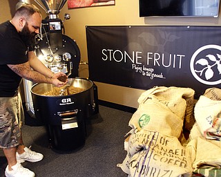        ROBERT K. YOSAY  | THE VINDICATOR..Ben Ilich,  checcks the beans as they are cooled..StoneFruit - Canfield coffee shop t Joshua and Jennifer,(Jennifer Rodway, 25, of Liberty, co-owns the business with her husband, Josh Langenheim, 30, also of Liberty.) married couple, who have imported Roasting machines from heavy coffee countries Morrocco and Turkey. They will also have a coffee shop within the Canfield Public Library once it is open..