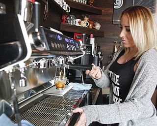        ROBERT K. YOSAY  | THE VINDICATOR..Jennifer carefully makes an expresso made with the fresh roasted and freshly ground coffee beans ..w with the StoneFruit - Canfield coffee shop t Joshua and Jennifer,(Jennifer Rodway, 25, of Liberty, co-owns the business with her husband, Josh Langenheim, 30, also of Liberty.) married couple, who have imported Roasting machines from heavy coffee countries Morrocco and Turkey. They will also have a coffee shop within the Canfield Public Library once it is open..