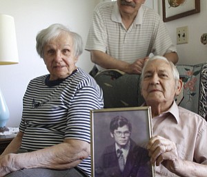        ROBERT K. YOSAY  | THE VINDICATOR..David Popa was killed in a firebombing at an East Side apartment in 1993. his family Charles Jane and David  with his photo ( high school).