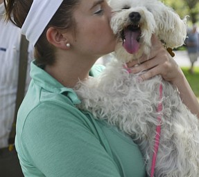 Katie Rickman | The Vindicator.Annabelle Himes of Canfield kisses her grandparents dog Dazzle while they wait for the annual Animal Blessing at St. James the Episcopal Church in Boardman to begin.