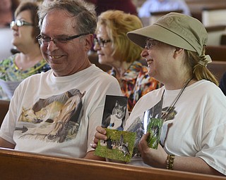 Katie Rickman | The Vindicator.John Pasternack of New Middletown sits next to his wife Georgia who holds photos of several of their animals as they wait for the annual Animal Blessing to begin at St. James the Episcopal Church in Boardman on Sunday May 10, 2015.