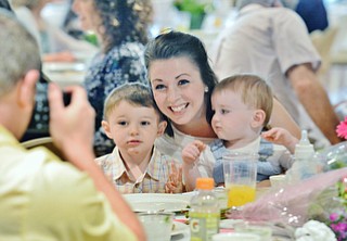 Jeff Lange | The Vindicator  MAY 10, 2015 - Cassie Oles of Canfield poses for a picture with her sons at left Noah age 2, and Cameron fourteen months. Oles and her siblings surprised her mother Patti Mosure by taking her and other family members to the Mothers Day brunch at Fellows Riverside Gardens, Sunday morning.