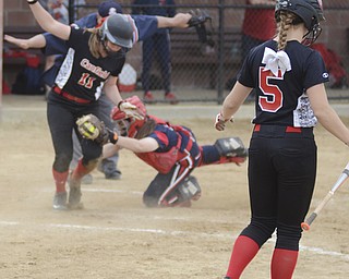 Katie Rickman | The Vindicator.Canfield's Jill Baker (11) runs in safe as Girard's Ashley Ellwood (54)stretches to attempt to tag her out inning against Girard at Canfield High School on May 12, 2015. Canfield's Ally Sammarco (5) watches while waiting on-deck.