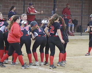 Katie Rickman | The Vindicator.Canfield's Ally Sammarco (5) runs into home base after hitting a home-run, the team waits at the base to celebrate the play during the fifth inning against Girard at Canfield High School on May 12, 2015.