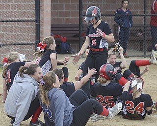 Katie Rickman | The Vindicator.Canfield's Ally Sammarco (5) runs into home base after hitting a home-run as members of the team fall to the ground in celebration during the fifth inning against Girard at Canfield High School on May 12, 2015.