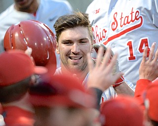 Jeff Lange | The Youngstown Vindicator - May 12, 2015 - Ohio State's Pat Porter is welcomed back into the dugout after crushing a two-run homer over the center field wall to make the score 6-0 over the Youngstown State University Penguins in the eighth inning of Tuesday night's game at Eastwood Field in Niles, OH. The Buckeyes shutout the Penguins 7-0.