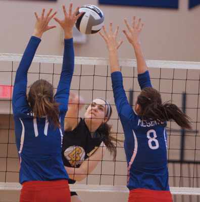 Dustin Livesay  |  The Vindicator.Western Reserve's Sydney Miller (8) and Kalina Wisniewski (17) jump to try and block a spike by Crestview's Abbie Gallagher (18) during the matchup at Western Reserve High School on Saturday, September 27, 2014 in Berlin Center, Ohio.