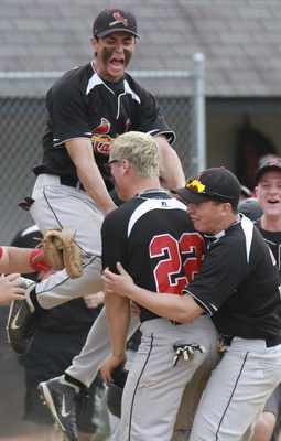 William D Lewis the vindicator Canfield's Mike Sebes(22) gets congrats from David Shaffer(12), left, and Nick Dastoli(3) after scoring winning running in game with niles thursday 5-14 at Canfield.