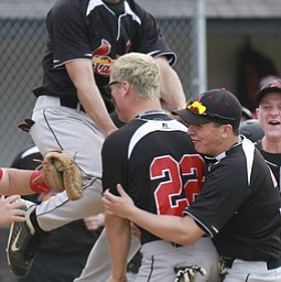 William D Lewis the vindicator Canfield's Mike Sebes(22) gets congrats from David Shaffer(12), left, and Nick Dastoli(3) after scoring winning running in game with niles thursday 5-14 at Canfield.