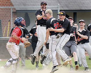 William D Lewis the vindicator Canfield's Mike Sebes(22) gets congrats from David Shaffer(12), left, and Nick Dastoli(3) after scoring winning running in game with niles thursday 5-14 at Canfield. At left is Niles catcher Cameron carson(7) who was reacting to a close call at the plate.