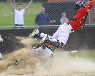 William D Lewis the vindicator Canfield'sMike Sebes(22) heads toward the plate upsetting Niles catcher Cameron carson(7)to score winning running in game with niles thursday 5-14 at Canfield.