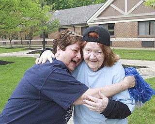 William D Lewis The Vindicator  Estheer O'Malley,86, a resident of Beeghley Oaks Nursing Home in Boardman gets a hug from Beeghley employee Carol Zeigler , left, after scoring in a baseball game 5-15-15. Members of the Struthers HS baseball team visited the facility as part of National Nursing Home Week  and played a few innings with the residents.