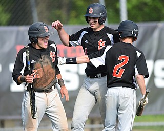 NEW MIDDLETOWN, OHIO - MAY 15, 2015: Hunter Snyder #23 and Brandon Chamberlain #8 of Springfield are congratulated by teammate Cody Allen #2 after scoring a pair of runs in the bottom of the 4th inning during a game Friday afternoon at Springfield High School. (Photo by David Dermer/Youngstown Vindicator)