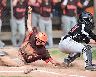 NEW MIDDLETOWN, OHIO - MAY 15, 2015: Ian Elliot #6 of East Palestine slides across home plate to score a run being the tag of catcher Hunter Snyder #23 of Springfield in the top of the 2nd inning during a game Friday afternoon at Springfield High School. (Photo by David Dermer/Youngstown Vindicator)