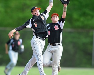 NEW MIDDLETOWN, OHIO - MAY 15, 2015: Second basemen Jordon Peterson #3 leaps in the air to catch the ball on a steal attempt while short stop Brandon Chamberlain #8 of Springfield catches the ball behind him during the top of the 2nd inning during a game Friday afternoon at Springfield High School. (Photo by David Dermer/Youngstown Vindicator)