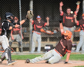 NEW MIDDLETOWN, OHIO - MAY 15, 2015: Alex Guy #3 of East Palestine slides into home to score a run being the throw from the outfield and tag by catcher Hunter Snyder #23 of Springfield in the top of the 7th inning during a game Friday afternoon at Springfield High School. (Photo by David Dermer/Youngstown Vindicator)