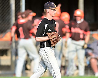 NEW MIDDLETOWN, OHIO - MAY 15, 2015: Pitcher Dalton Donachie #3 of Springfield walks back to the mound while East Palestine players celebrate behind him after a run scored in the top of the 7th inning during a game Friday afternoon at Springfield High School. (Photo by David Dermer/Youngstown Vindicator)