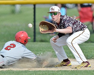 Jeff Lange | The Vindicator  MAY 15, 2015 - South Range first baseman Tyler Baird looks to make a catch from the mound as Columbiana's Mitchell Davidson slides safely into the bag in the top of the sixth inning of Friday's game at South Range High School.