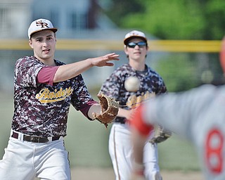 Jeff Lange | The Vindicator  MAY 15, 2015 - South Range pitcher Greg Dunham (left) makes a throw to first in attempt to put out Columbiana batter Keenan Green in the top of the fourth inning of Friday's game at South Range High School.