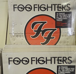 Katie Rickman | The Vindicator.Foo Fighters "Greatest Hits" record at The Record Connection in Niles holds a Foo Fighters record as he stands in his record store on May 12, 2015. Burke's store was the location of a performance by Foo Fighters for National Record Store last month, he says his business has picked up since the show.